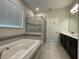 Bathroom with soaking tub, shower, and double vanity at 14154 Dove Hollow Dr, Orlando, FL 32824