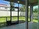 Screened patio with view of grassy backyard and pet door at 14154 Dove Hollow Dr, Orlando, FL 32824