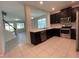 Modern kitchen with dark cabinetry, stainless steel appliances, and granite countertops at 14154 Dove Hollow Dr, Orlando, FL 32824