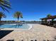 Community pool area with a view of the lake and playground at 14154 Dove Hollow Dr, Orlando, FL 32824
