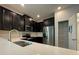 Modern kitchen with double sink, granite countertops, and stainless steel appliances at 14154 Dove Hollow Dr, Orlando, FL 32824
