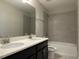 Bathroom with double vanity, bathtub, and shower at 14154 Dove Hollow Dr, Orlando, FL 32824