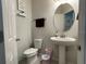 Clean powder room with pedestal sink and toilet at 14154 Dove Hollow Dr, Orlando, FL 32824