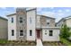 Modern two-story home with stone accents and landscaping at 2726 Oxymoron Way, Kissimmee, FL 34746