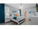 Bright bedroom with a queen bed and ensuite bathroom at 2726 Oxymoron Way, Kissimmee, FL 34746