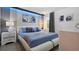 Modern bedroom with a white platform bed, blue bedding, and a nightstand at 2726 Oxymoron Way, Kissimmee, FL 34746