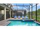 Enclosed pool and spa area with lounge chairs and brick pavers at 2726 Oxymoron Way, Kissimmee, FL 34746