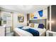 Spacious bedroom with a king bed, artwork, and modern lighting at 3020 Mahalo Dr, Davenport, FL 33897