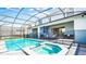 Inviting pool and spa area with covered lanai and safety fence at 3020 Mahalo Dr, Davenport, FL 33897