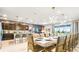 Elegant dining room with large table and modern chandelier at 3020 Mahalo Dr, Davenport, FL 33897