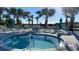 Relaxing hot tub surrounded by lounge chairs at 3020 Mahalo Dr, Davenport, FL 33897