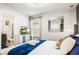 Bright bedroom with a king-size bed, en-suite bathroom, and stylish decor at 3020 Mahalo Dr, Davenport, FL 33897