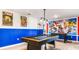 Fun game room with pool table, foosball, and Marvel theme at 3020 Mahalo Dr, Davenport, FL 33897