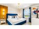 Modern bedroom with a king-size bed and blue velvet headboard at 3020 Mahalo Dr, Davenport, FL 33897