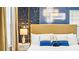 Elegant bedroom with a king-size bed and stylish blue and gold accents at 3020 Mahalo Dr, Davenport, FL 33897