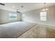 Bright and spacious living room with large windows and neutral carpeting at 3654 Sagefield Dr, St Cloud, FL 34773