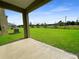 Large backyard with grassy area and covered patio at 3654 Sagefield Dr, St Cloud, FL 34773