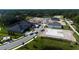 Aerial view of homes under construction with trucks and construction materials at 128 Lake Dr, Oviedo, FL 32765