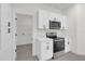 White cabinets, stainless steel appliances and laundry hookups at 95 Malauka Place Trak, Ocklawaha, FL 32179