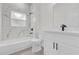 Modern bathroom with white cabinets, quartz countertop, and marble shower at 95 Malauka Place Trak, Ocklawaha, FL 32179