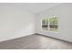 Spacious bedroom with a large window and wood-look floors at 95 Malauka Place Trak, Ocklawaha, FL 32179