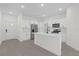 Modern kitchen with white cabinets, stainless steel appliances, and an island at 95 Malauka Place Trak, Ocklawaha, FL 32179