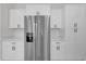 White kitchen cabinets and stainless steel appliances at 95 Malauka Place Trak, Ocklawaha, FL 32179
