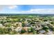 Aerial view of a neighborhood showcasing houses, trees, and a pond at 2124 Fish Eagle St, Clermont, FL 34714