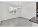 Bright dining area with tile flooring and a chandelier at 5115 Lake Hamlin Trl, Winter Garden, FL 34787