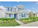 Two-story home with blue shutters and landscaped front yard at 5115 Lake Hamlin Trl, Winter Garden, FL 34787