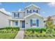 Two-story home with blue shutters and landscaped front yard at 5115 Lake Hamlin Trl, Winter Garden, FL 34787