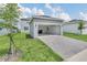 Detached garage with paver driveway and grassy yard at 5115 Lake Hamlin Trl, Winter Garden, FL 34787