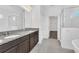 Double vanity bathroom with granite countertop and shower at 5115 Lake Hamlin Trl, Winter Garden, FL 34787