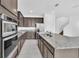 Modern kitchen with stainless steel appliances and granite countertops at 5115 Lake Hamlin Trl, Winter Garden, FL 34787