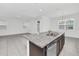 Modern kitchen with island, granite countertops, and stainless steel appliances at 5115 Lake Hamlin Trl, Winter Garden, FL 34787