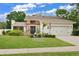 Beautiful home exterior, showcasing landscaping and a two-car garage at 603 Antilla Ave, Altamonte Springs, FL 32714