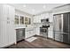 Modern white kitchen with stainless steel appliances and farmhouse sink at 603 Antilla Ave, Altamonte Springs, FL 32714
