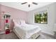 Bedroom with a queen bed, built-in shelves, and a window view at 603 Antilla Ave, Altamonte Springs, FL 32714