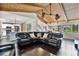 Open concept living room with cathedral ceiling, hardwood floors, and leather sectional at 603 Antilla Ave, Altamonte Springs, FL 32714