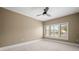 Spacious bedroom with neutral walls, ceiling fan, and large window with shutters at 10409 Trout Rd, Orlando, FL 32836