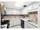 Bright kitchen features white cabinets, granite countertops, and modern appliances at 200 Maitland Ave # 174, Altamonte Springs, FL 32701