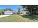 Newly renovated home with a white exterior and landscaping at 1030 Gregory Dr, Maitland, FL 32751