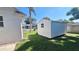White storage shed with a window, in the backyard at 1030 Gregory Dr, Maitland, FL 32751