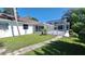 Home's backyard with a screened pool and grassy lawn at 1030 Gregory Dr, Maitland, FL 32751