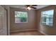 Light-filled bedroom with tile floors and dual windows at 1030 Gregory Dr, Maitland, FL 32751