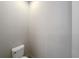 Small powder room with toilet and wall-mounted shelves at 7574 Marker Ave, Kissimmee, FL 34747