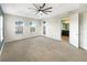 Spacious main bedroom with carpet, ceiling fan, and en-suite bathroom at 7574 Marker Ave, Kissimmee, FL 34747