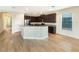 Modern kitchen features an island and dark cabinetry at 7574 Marker Ave, Kissimmee, FL 34747