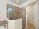Bathroom with walk-in shower and tile surround at 7574 Marker Ave, Kissimmee, FL 34747