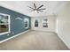 Main bedroom with neutral walls, carpet, and three windows at 7574 Marker Ave, Kissimmee, FL 34747